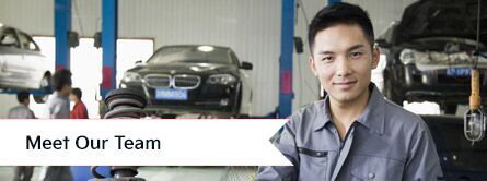 meet our team with mechanic posing for camera