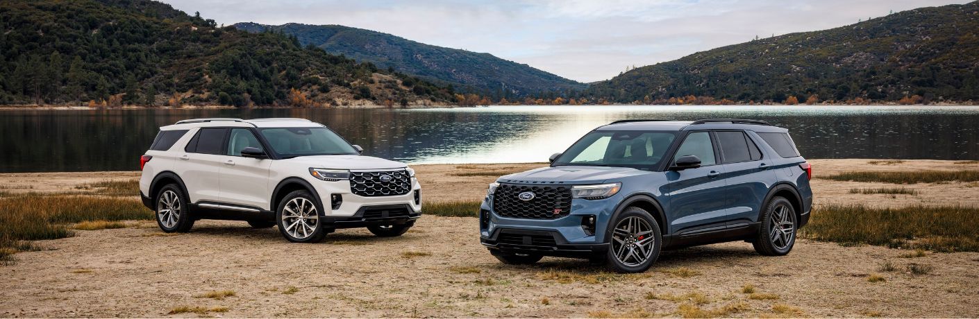 2025 Ford Explorer models on a beach by a lake