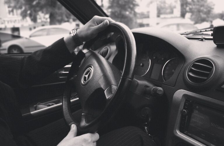 Black and white photo of a Mercedes-Benz steering wheel