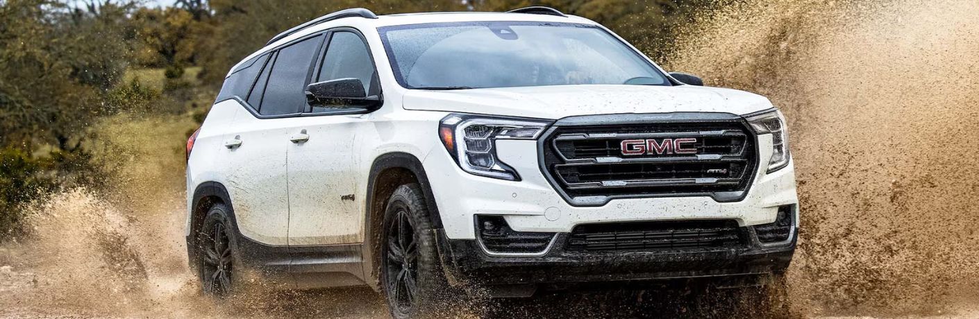 A 2024 GMC Terrain splashing through muddy water