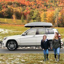 two people walking away from a parked Mercedes-Benz SUV in the fall