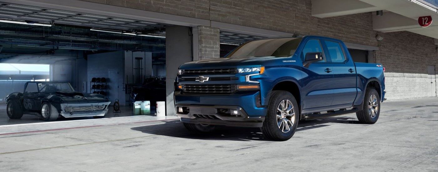 Blue 2019 Chevy Silverado 1500 outside of a garage