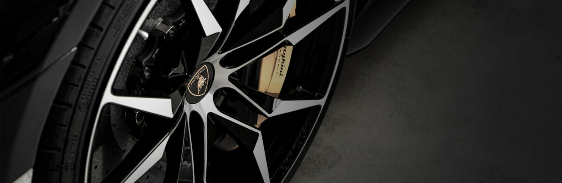 Close up of an auto wheel that is undergoing front-end alignment service