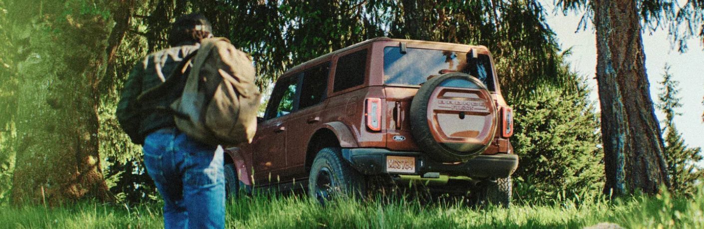 2027 Ford Bronco Filson parked in grass rear view