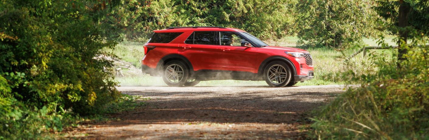 2025 Ford Explorer ST side view by a forest