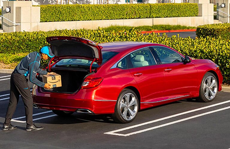 Man Loading Cargo in Rear of Red 2021 Honda Accord