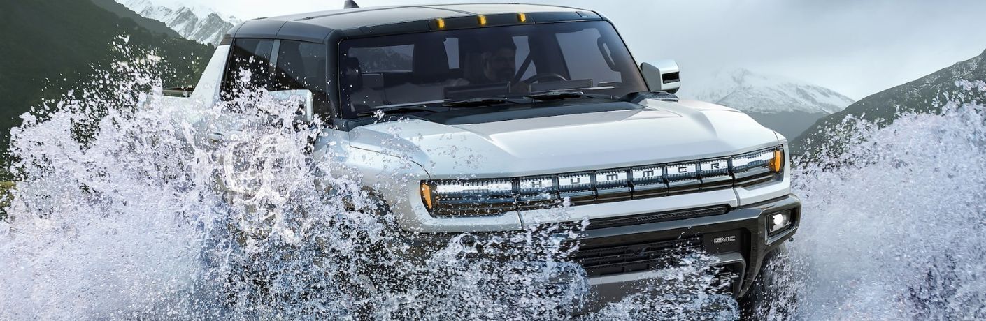 2023 GMC Hummer crossing a stream