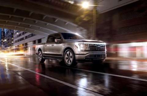 2022 Ford F-150 Lightning on city road at night