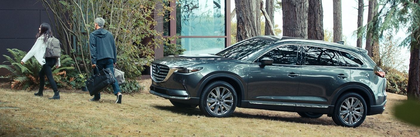 Mazda SUV parked near a house