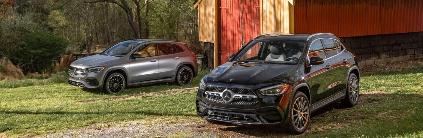 2 2021 MB GLA models front fascia and driver sides in front of barn