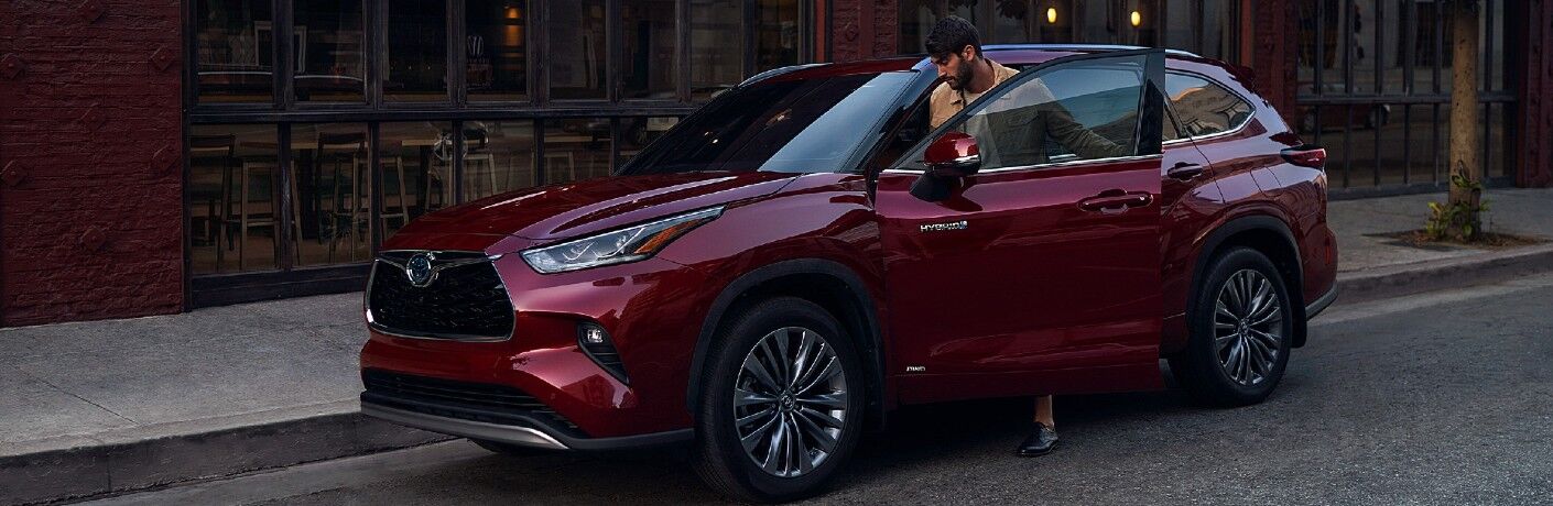 Individual entering red 2021 Toyota Highlander Hybrid