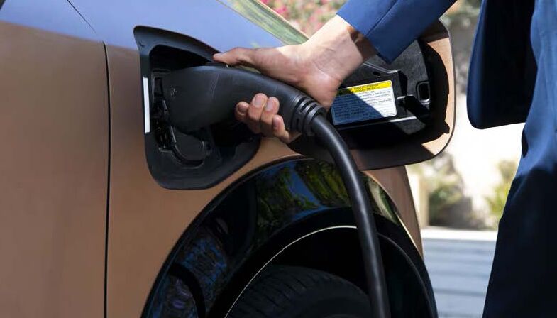 Charging outlet being plugged into a Nissan EV