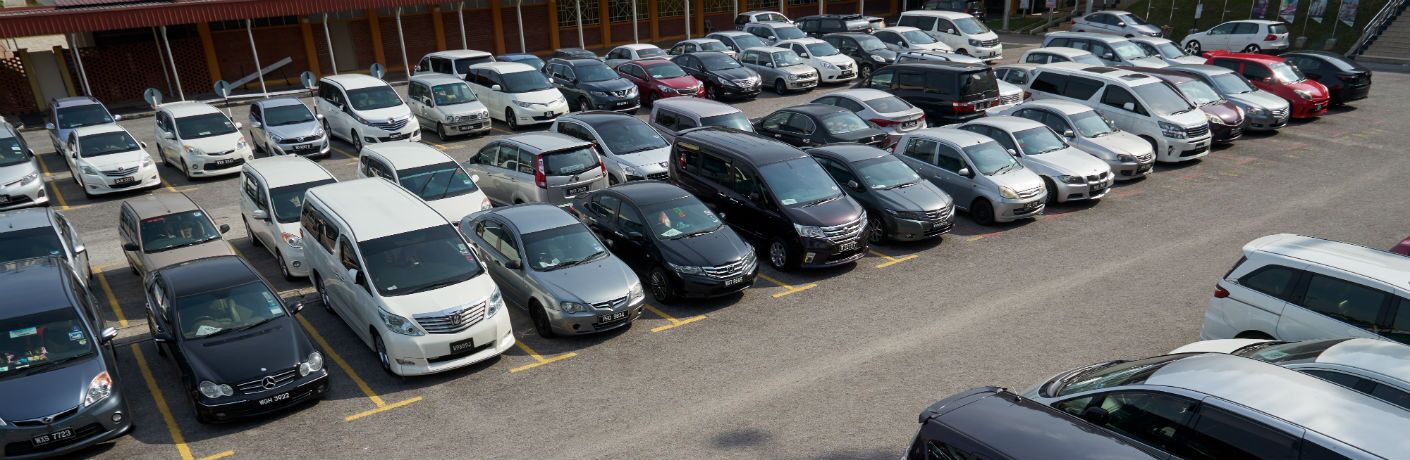 Many cars parked in car lot