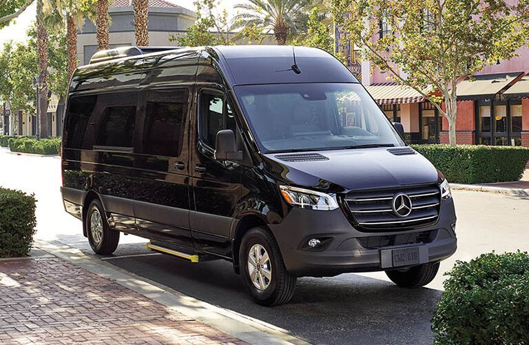 black mercedes-benz metris passenger van on a road