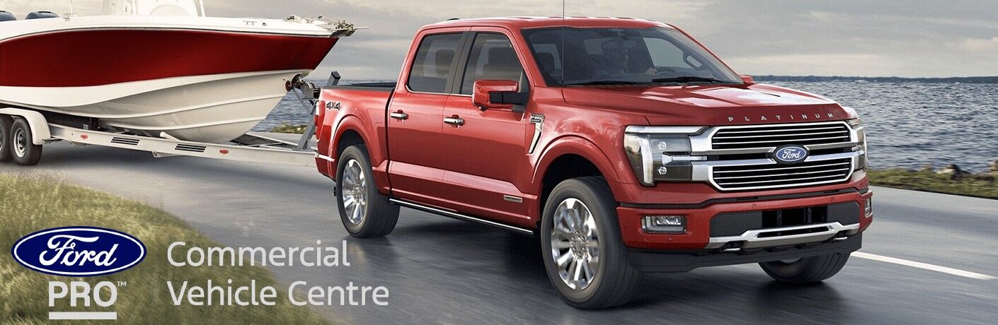 2024 Ford F-150 towing a boat on a curved road