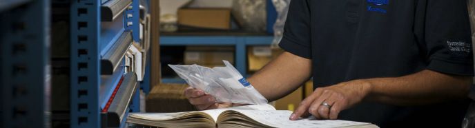 Service tech looking in a book