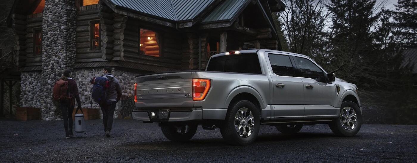 Silver 2022 Ford F-150 parked at a cabin in the woods