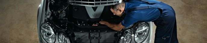 Service tech working under a hood