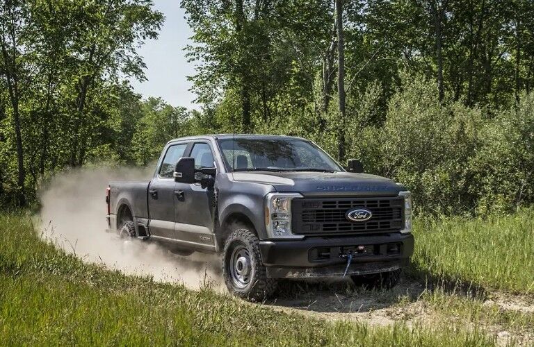 2025 Ford F-Series Super Duty driving off-road on a dirt trail