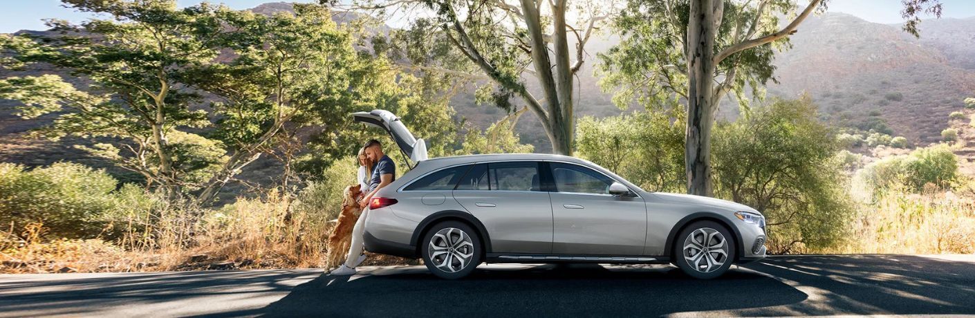 side view image of the 2024 Mercedes-Benz E 450 4MATIC All-Terrain Wagon parked on a road with its owners
