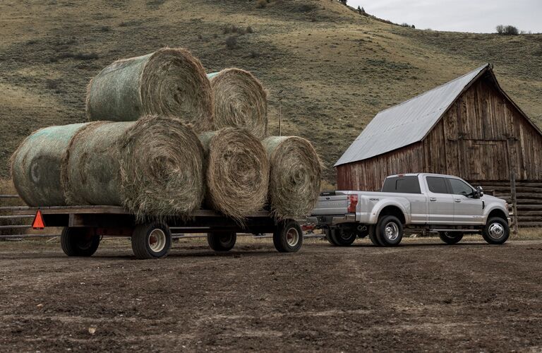2020 Ford Super Duty pulling rolls of hay