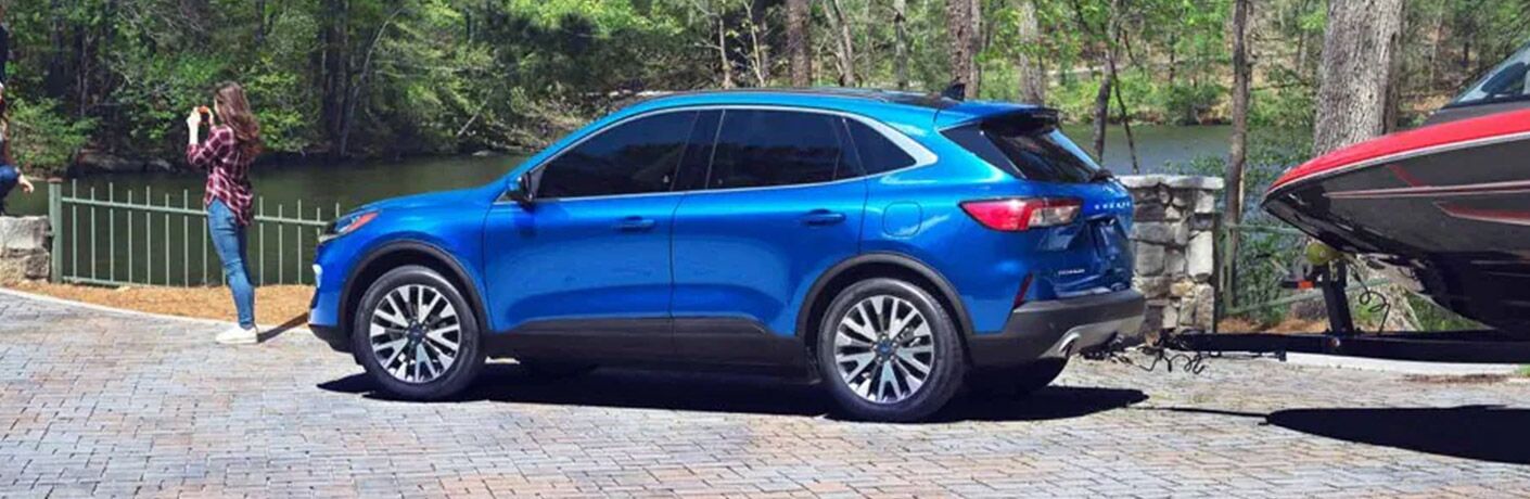 2021 Ford Escape SEL Hybrid side view parked with a boat