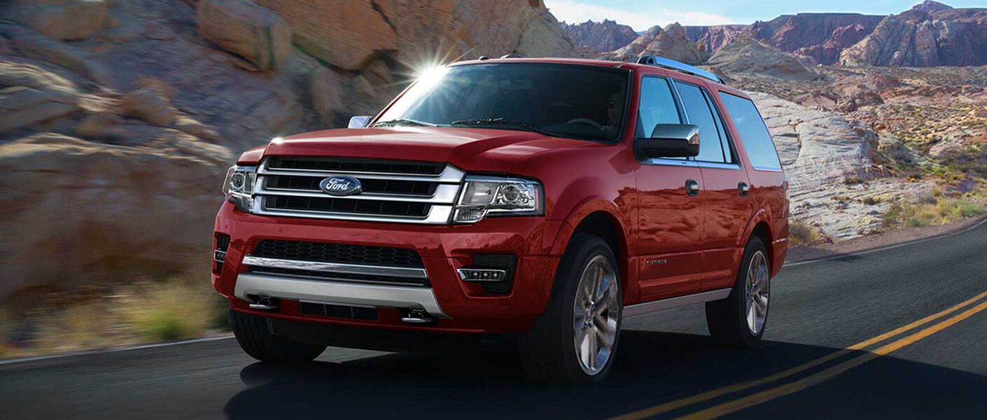 red 2017 Ford Expedition front driver side driving rock formations around