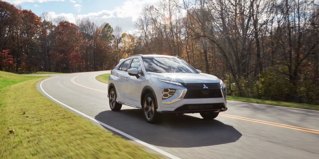 2022 Mitsubishi Outlander white parked in back yard