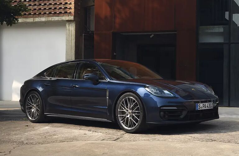 blue 2021 Porsche Panamera front fascia passenger side parked in front of house