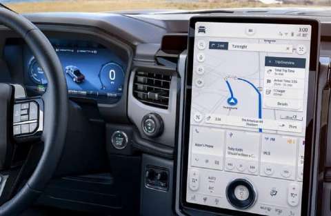 2022 Ford F-150 Lightning inside a home garage plugged in for charging