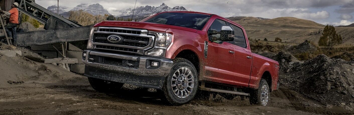 Red 2020 Ford F-250 Super Duty driving through mud