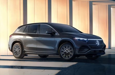 mercedes-benz e-class wagon parked outside city with skyscrapers