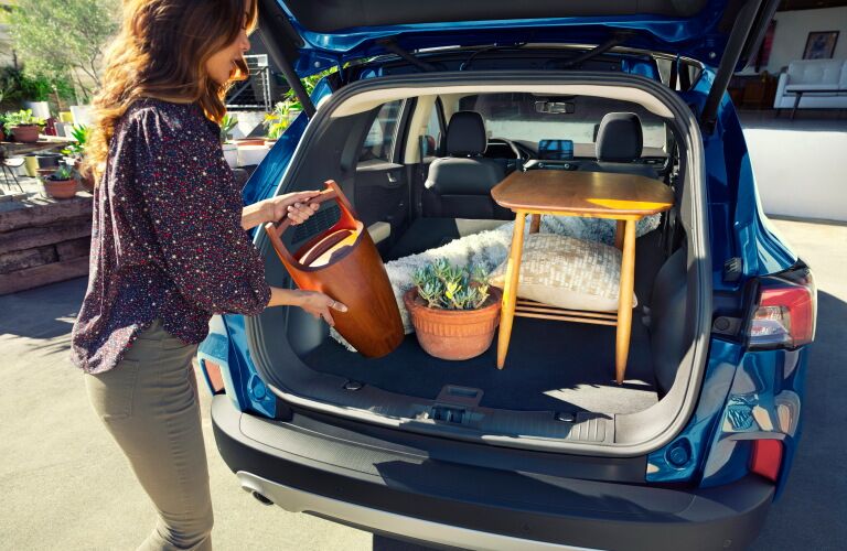 Woman loading cargo in rear area of 2020 Ford Escape