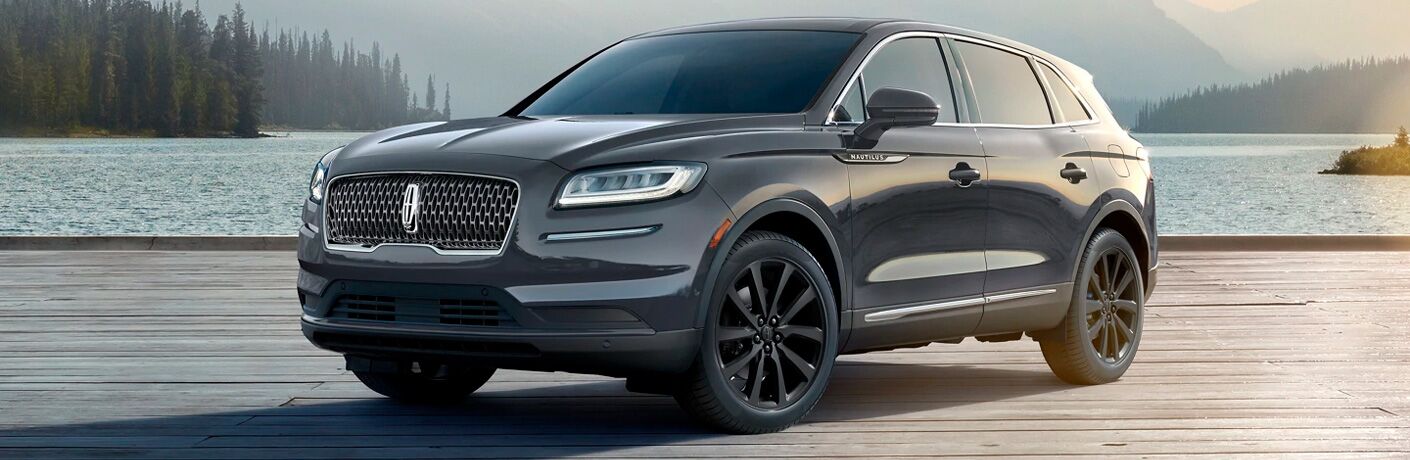2021 Lincoln Nautilus dark grey exterior front fascia driver side parked in front of lake