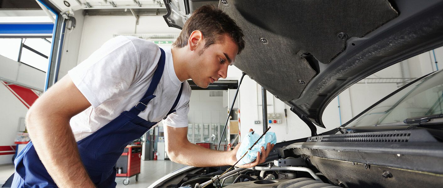 Mechanic checking oil