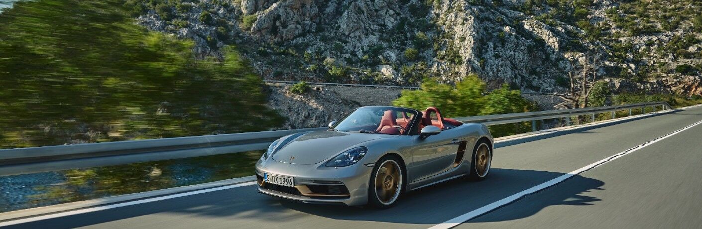 2021 Porsche 718 Boxster 25 years driving down road