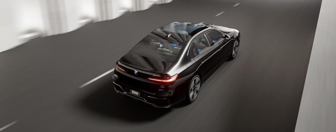 Black 2024 BMW i7 driving down a tunnel.