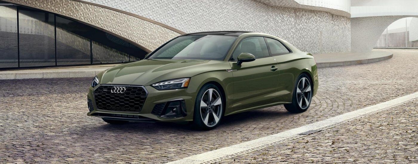 Green 2020 Audi A5 parked on a stone pathway