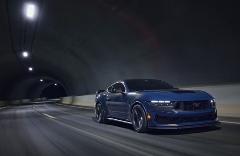 2025 Ford Mustang Dark Horse front and side view in a tunnel