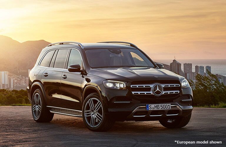 2021 Mercedes-Maybach GLS exterior front fascia passenger side in empty lot with city in distance