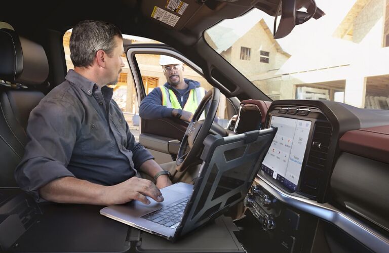 2021 Ford F-150 King Ranch with a man in the front seat