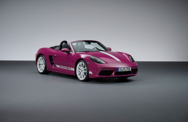 a pink Porsche car parked in a showroom