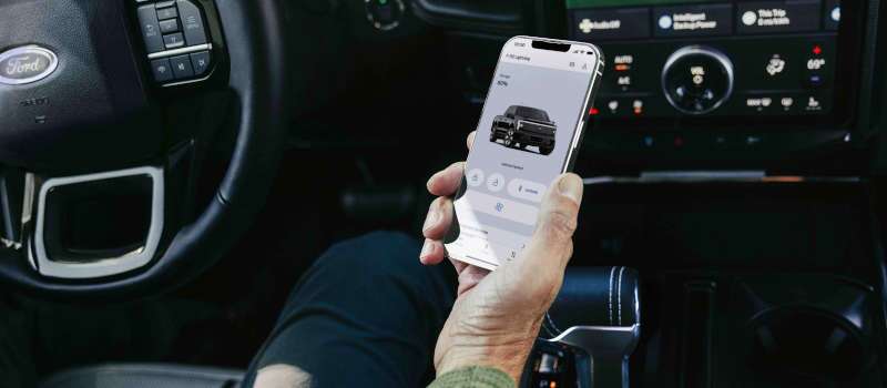 A man using the Ford connectivity features in the Lightning Flash