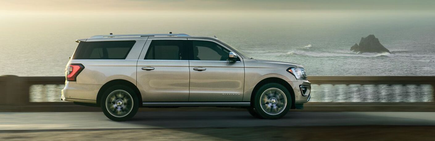 Profile view of 2019 Ford Expedition driving on waterfront