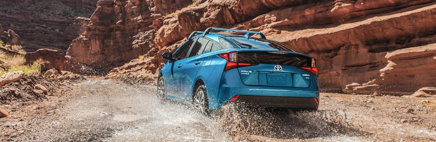 2022 Toyota Prius driving on a muddy road