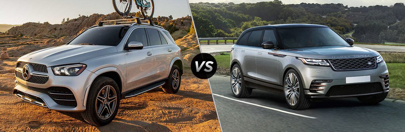 2021 MB GLE exterior front fascia driver side on rocky trail with bike vs 2021 Land Rover Range Rover Velar exterior front fascia passenger side in front of trees