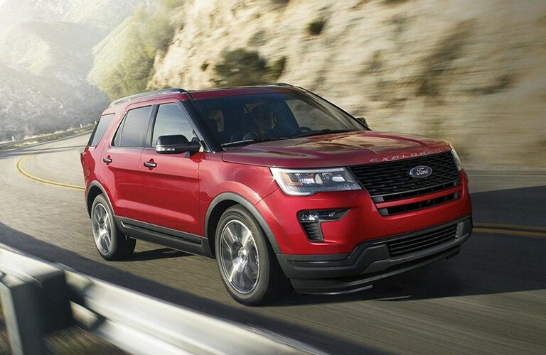 Red 2019 Ford Explorer driving on mountainous road