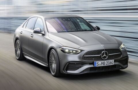 Front view of the 2023 Mercedes-Benz C-Class Hybrid Gray driving on the road