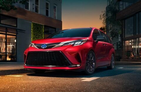 2022 Toyota Sienna Red parked outside a house