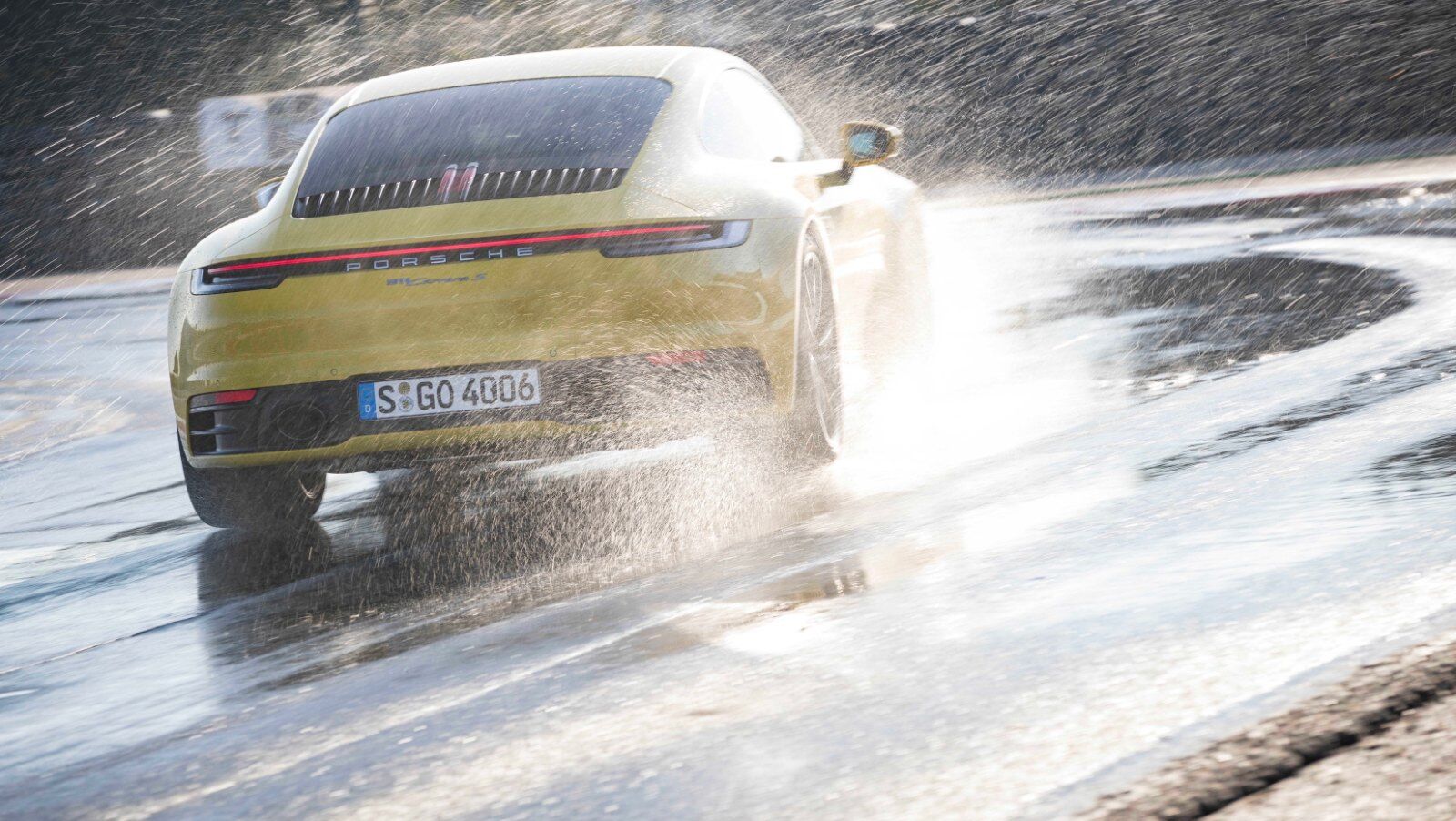 Porsche 911 throwing spray on a flooded road in Wet Mode – Champion Porsche Pompano Beach, FL